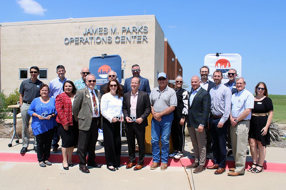 A group of people standing in front of a building